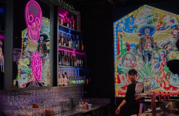The bar at Hecho en Mexico, lit by Day of the Dead murals